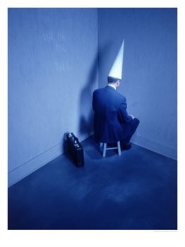 386410abusinessman-sitting-in-corner-with-dunce-hat-posters1.jpg